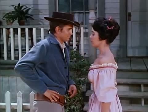 A young man and a woman on a porch